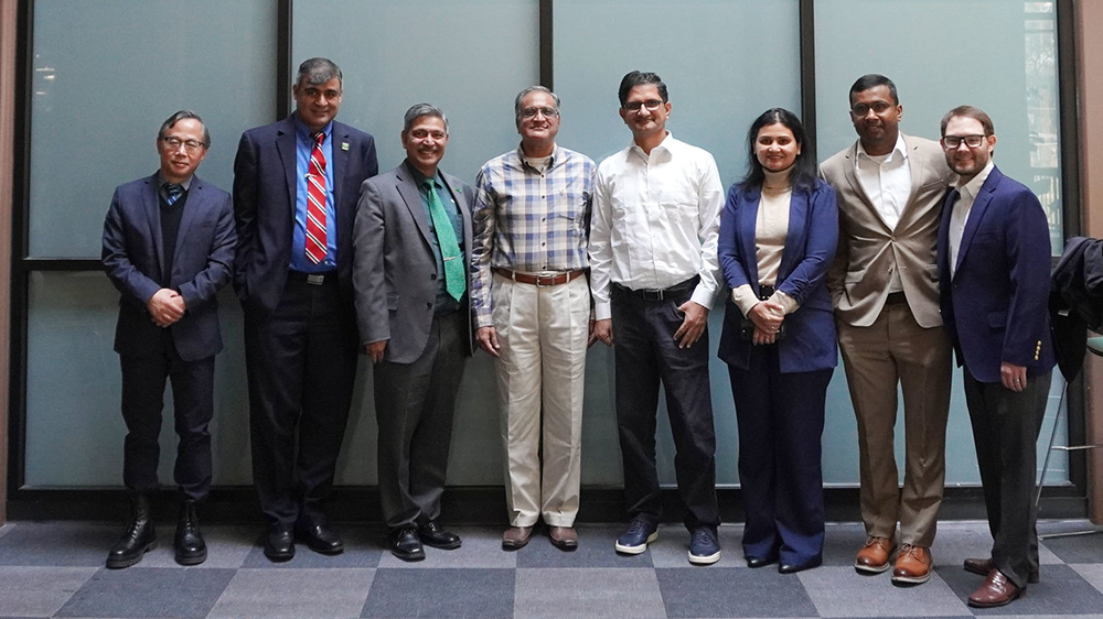 Data science faculty and guests standing together in a row.